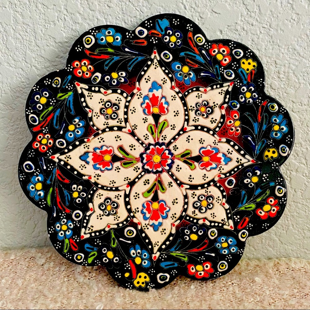 Scalloped tile/trivet, multi-colored, black background, raised surface, ceramic